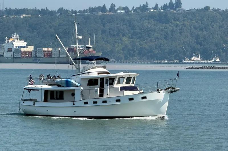  Yacht Photos Pics 1998 Kadey-Krogen 48' Northsea Widebody Pilothouse cruising in scenic waters.