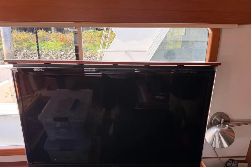  Yacht Photos Pics Interior view of 1998 Kadey-Krogen 48' Northsea Widebody Pilothouse with TV and window.