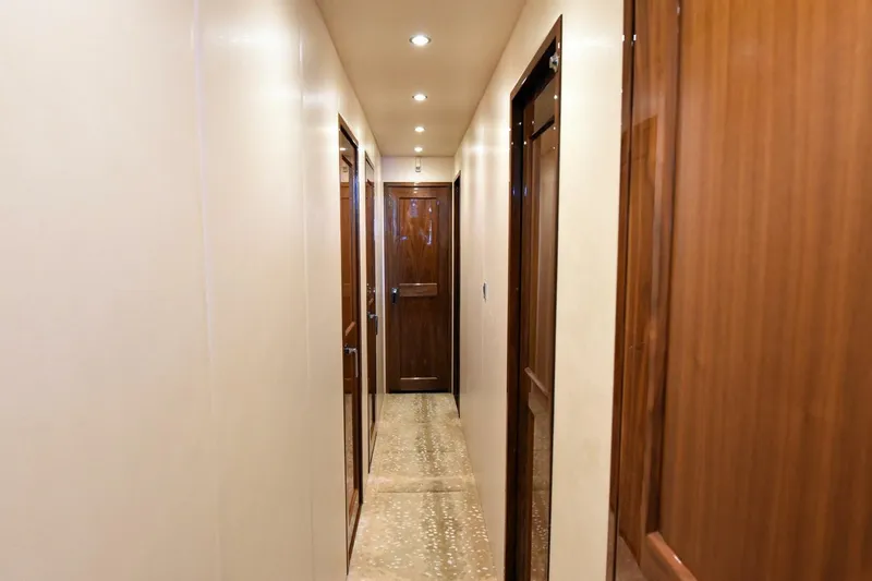 Party Of Five Yacht Photos Pics Luxurious hallway interior of 2019 Viking 80 Sky Bridge yacht with wooden doors.