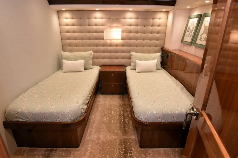 Party Of Five Yacht Photos Pics Luxurious twin bedroom in 2019 Viking 80 Sky Bridge yacht, featuring elegant decor and plush bedding.