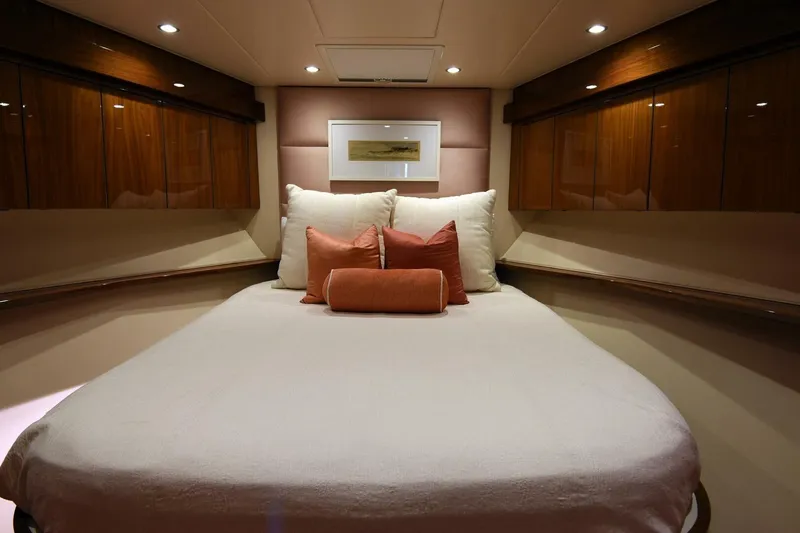Party Of Five Yacht Photos Pics Luxurious bedroom interior of 2019 Viking 80 Sky Bridge yacht with elegant wood finishes.