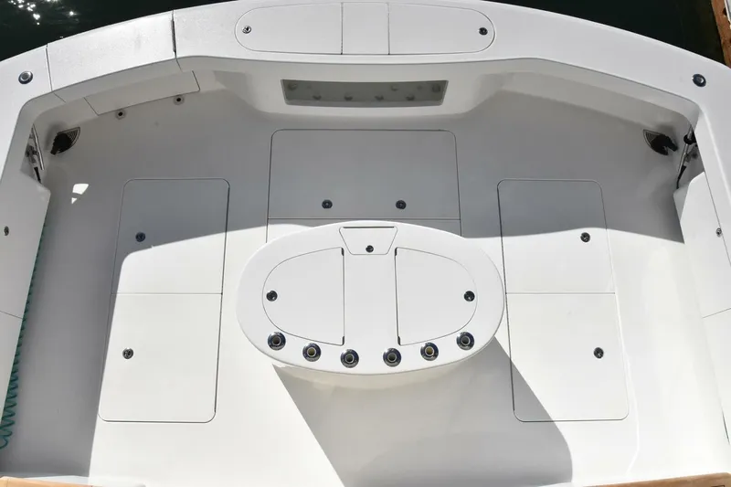 Party Of Five Yacht Photos Pics Cockpit view of 2019 Viking 80 Sky Bridge yacht, featuring sleek white design and storage compartments.