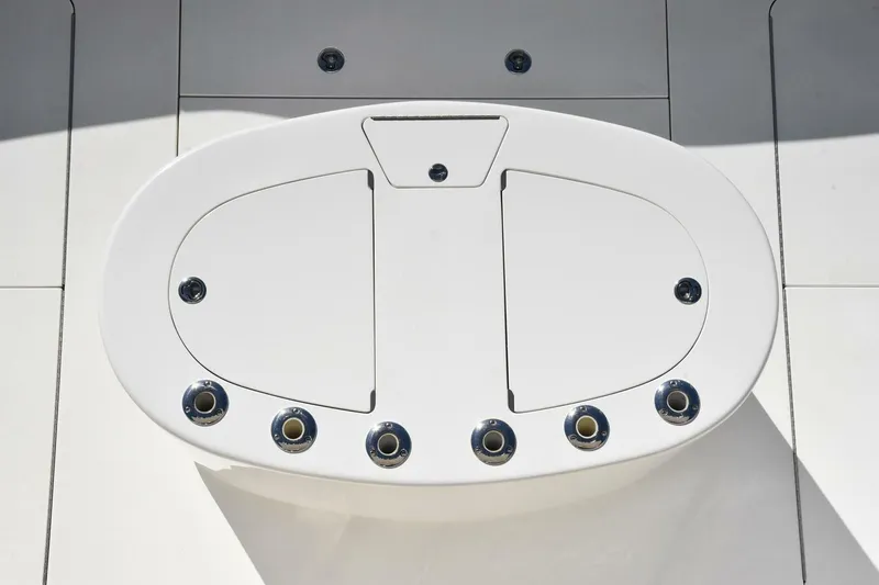 Party Of Five Yacht Photos Pics White deck hatch on 2019 Viking 80 Sky Bridge yacht, featuring multiple circular fittings.