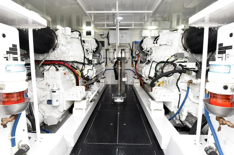 Party Of Five Yacht Photos Pics Engine room of 2019 Viking 80 Sky Bridge yacht, showcasing dual powerful engines.