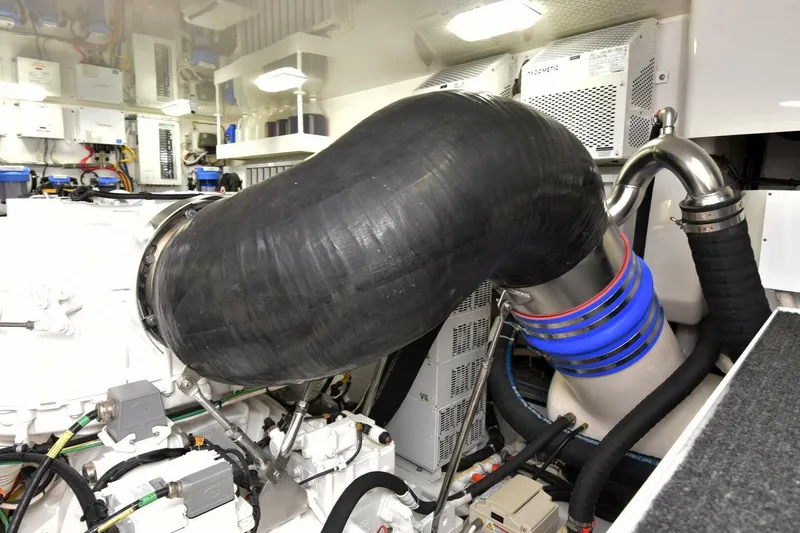 Party Of Five Yacht Photos Pics Engine room of 2019 Viking 80 Sky Bridge yacht with complex piping and machinery.