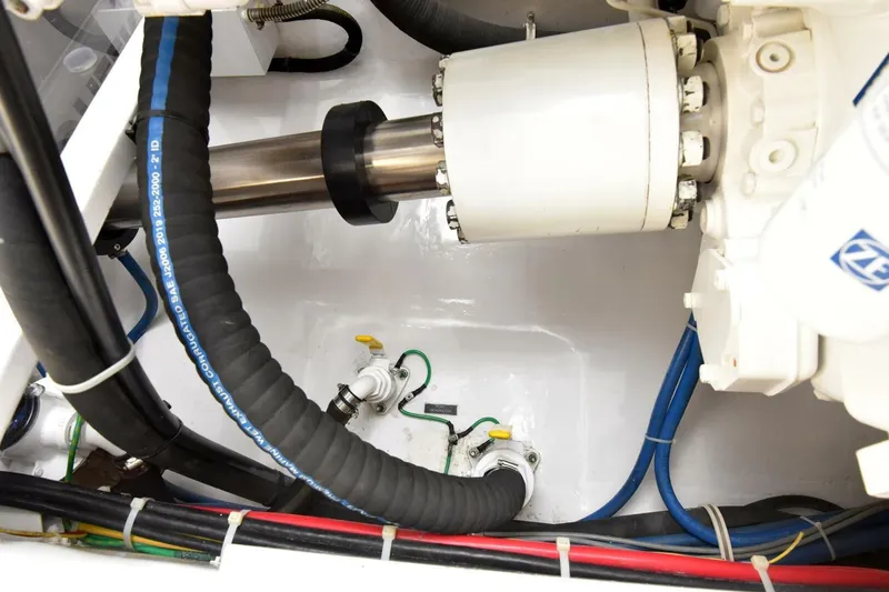 Party Of Five Yacht Photos Pics Engine room of 2019 Viking 80 Sky Bridge yacht, showcasing mechanical components and hoses.