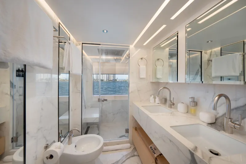 Santosh Yacht Photos Pics Luxurious bathroom on a 2020 Majesty 100 yacht with marble finishes and dual sinks.