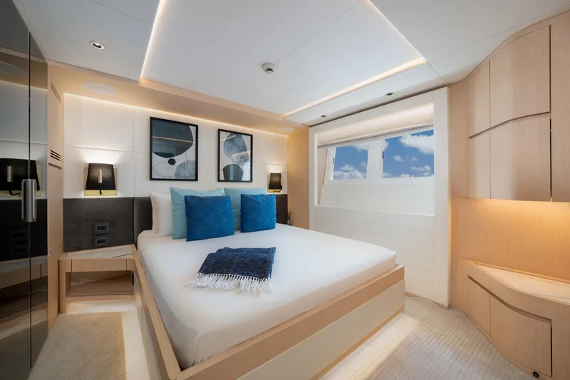 Santosh Yacht Photos Pics Luxurious bedroom interior of 2020 Majesty 100 yacht with modern decor and ocean view.