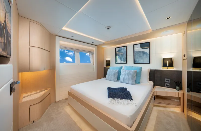 Santosh Yacht Photos Pics Luxurious bedroom interior of 2020 Majesty 100 yacht with modern decor and ocean view.