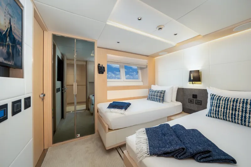 Santosh Yacht Photos Pics Luxurious twin bedroom on the 2020 Majesty 100 yacht with modern decor.