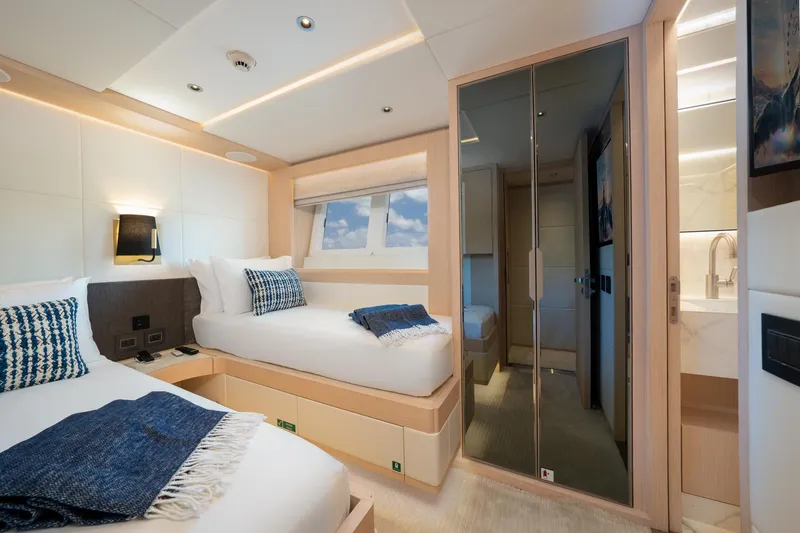 Santosh Yacht Photos Pics Luxurious cabin interior of 2020 Majesty 100 yacht with twin beds and modern decor.