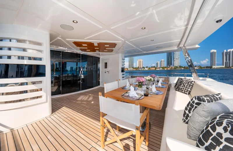 Santosh Yacht Photos Pics Luxury outdoor dining area on 2020 Majesty 100 yacht with ocean view.