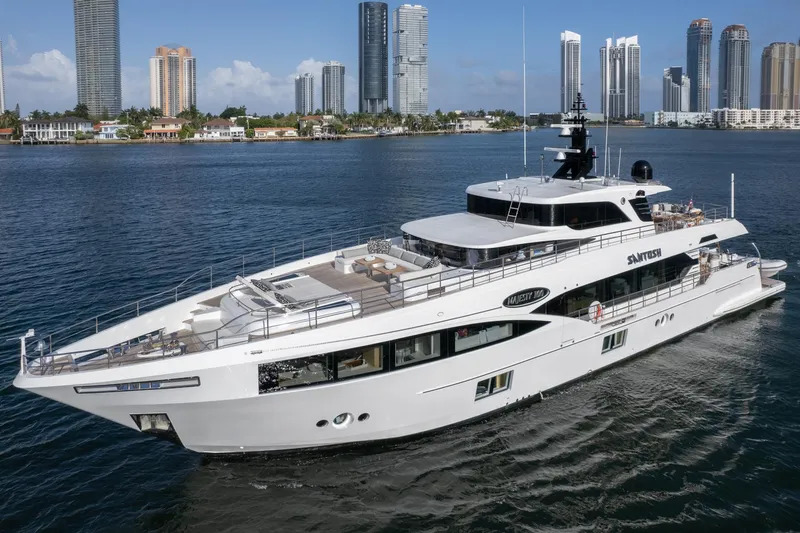 Santosh Yacht Photos Pics Majesty 100 yacht cruising near a city skyline, 2020 model.