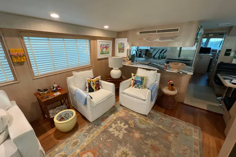 Moon River Yacht Photos Pics Luxurious interior of 1997 Hatteras 70 Sport Deck Motor Yacht with cozy seating and decor.