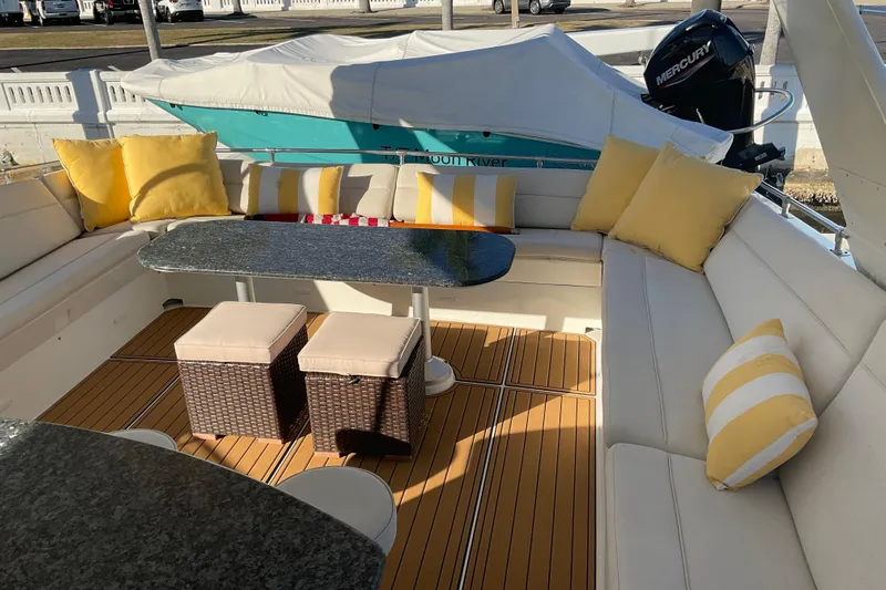 Moon River Yacht Photos Pics Luxurious 1997 Hatteras 70 Sport Deck Motor Yacht with elegant seating and vibrant cushions.