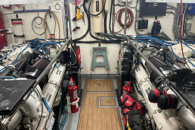 Moon River Yacht Photos Pics Engine room of a 1997 Hatteras 70 Sport Deck Motor Yacht, featuring Detroit Diesel engines.
