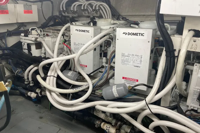 Moon River Yacht Photos Pics Engine room of 1997 Hatteras 70 Sport Deck Motor Yacht with Dometic equipment.