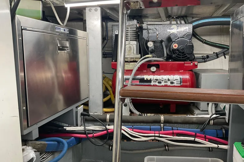 Moon River Yacht Photos Pics Engine room of 1997 Hatteras 70 Sport Deck Motor Yacht with Magna Force compressor.