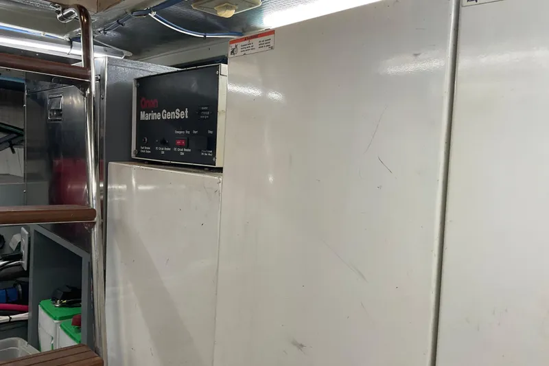 Moon River Yacht Photos Pics Engine room of 1997 Hatteras 70 Sport Deck Motor Yacht with Onan Marine GenSet.