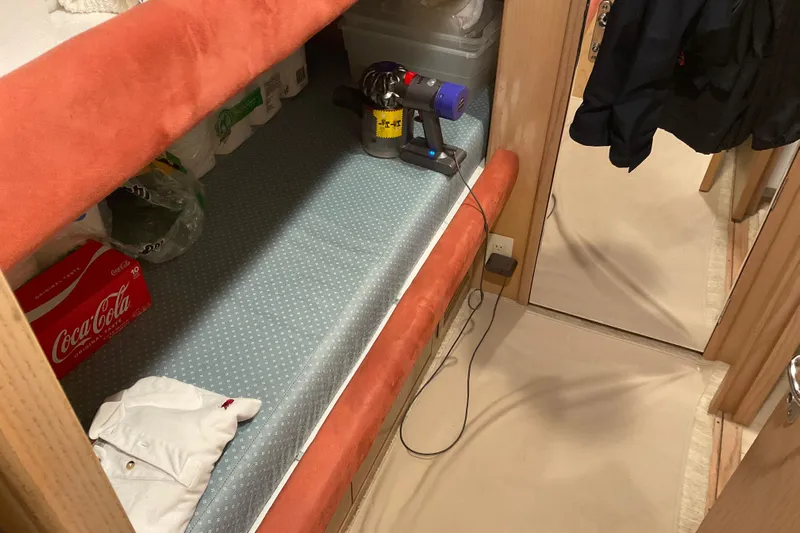 Moon River Yacht Photos Pics Interior of 1997 Hatteras 70 Sport Deck Motor Yacht with storage and cleaning supplies.