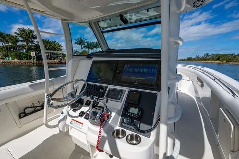  Yacht Photos Pics Boston Whaler 370 Outrage 2011 helm with advanced navigation system and scenic water view.