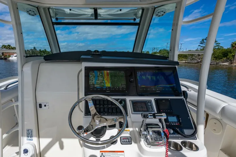 Yacht Photos Pics Cockpit of 2011 Boston Whaler 370 Outrage with advanced navigation systems and steering wheel.