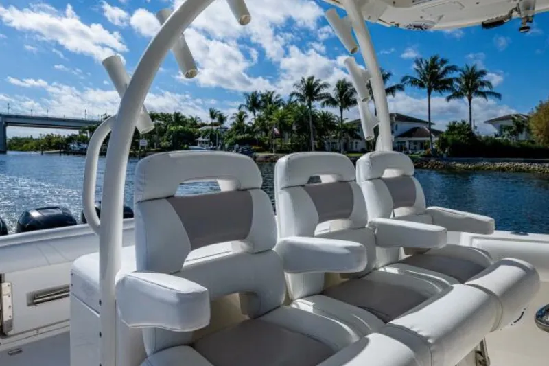  Yacht Photos Pics 2011 Boston Whaler 370 Outrage boat interior with luxurious seating, palm trees, and water view.