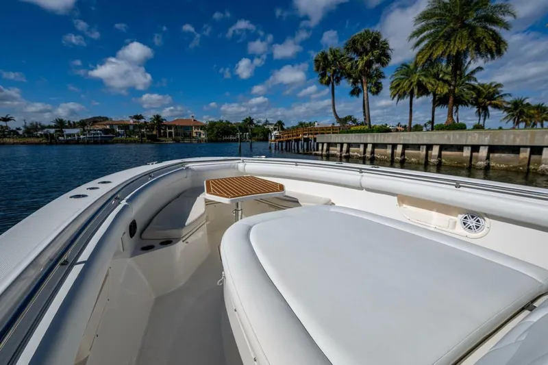  Yacht Photos Pics Boston Whaler 370 Outrage 2011 boat on water, palm trees, and blue sky background.