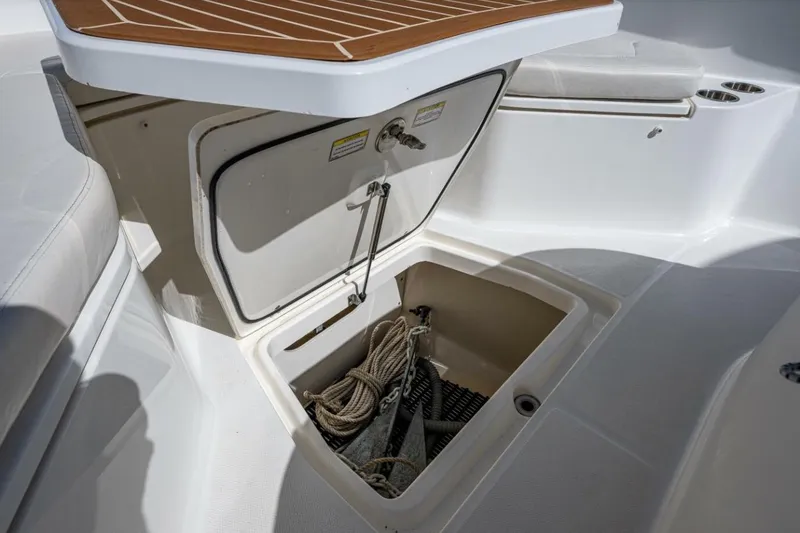  Yacht Photos Pics 2011 Boston Whaler 370 Outrage anchor storage compartment with rope and anchor visible.