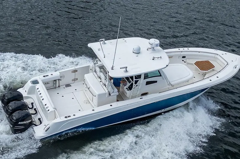  Yacht Photos Pics 2011 Boston Whaler 370 Outrage cruising on water, featuring triple Mercury engines.