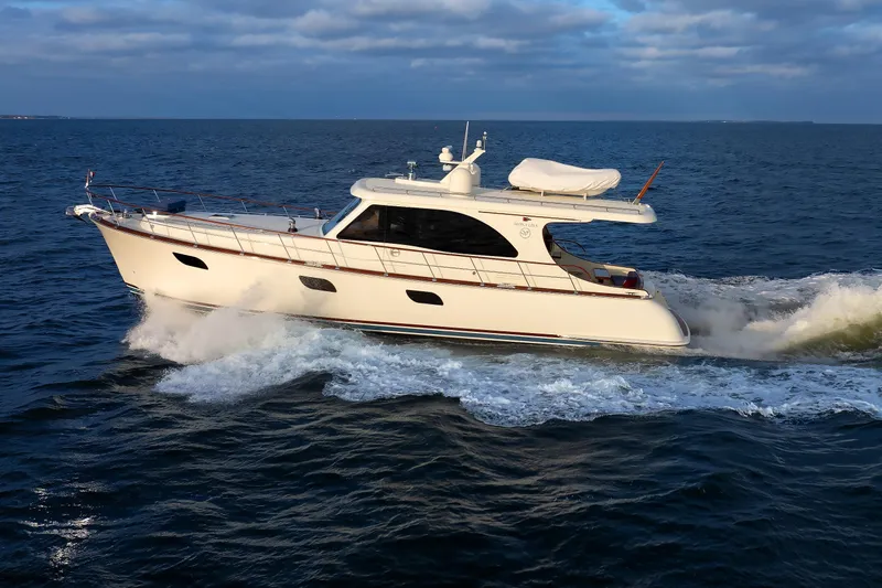 Mona Lisa Yacht Photos Pics 2025 Vicem 58 Classic yacht cruising on open sea under cloudy sky.