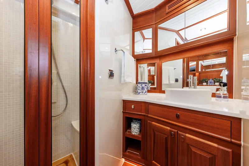 Mona Lisa Yacht Photos Pics Luxurious bathroom in 2025 Vicem 58 Classic yacht with elegant wood finishes and modern fixtures.