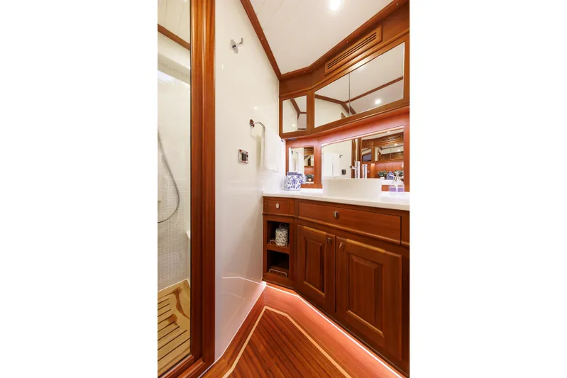 Mona Lisa Yacht Photos Pics Luxurious bathroom in 2025 Vicem 58 Classic yacht with elegant wood cabinetry and modern fixtures.