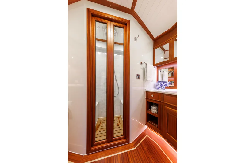 Mona Lisa Yacht Photos Pics Luxurious bathroom interior of 2025 Vicem 58 Classic yacht with wooden accents and modern shower.