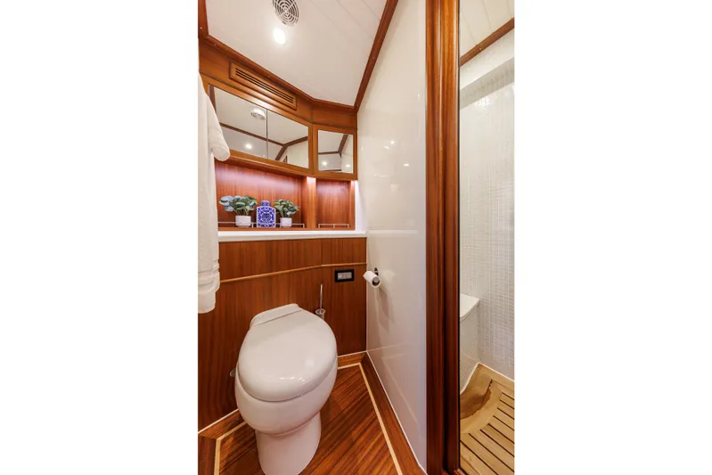 Mona Lisa Yacht Photos Pics Luxurious bathroom in 2025 Vicem 58 Classic yacht with wood accents and modern fixtures.