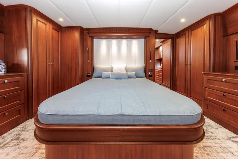 Mona Lisa Yacht Photos Pics Luxurious 2025 Vicem 58 Classic yacht bedroom with elegant wood paneling and modern lighting.