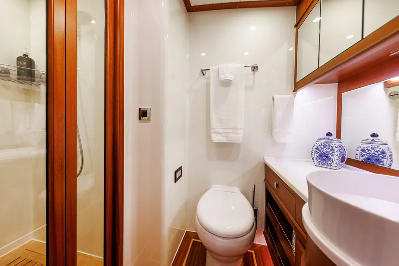 Mona Lisa Yacht Photos Pics Luxurious bathroom in 2025 Vicem 58 Classic yacht with elegant wood accents.