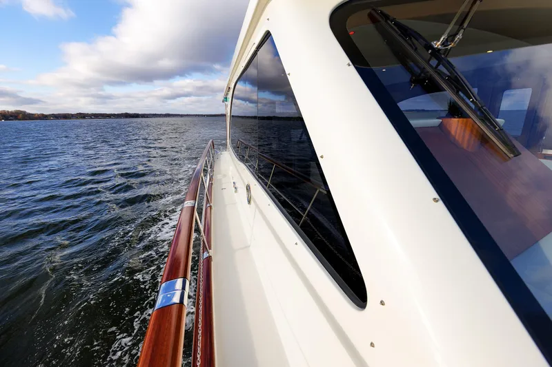 Mona Lisa Yacht Photos Pics 2025 Vicem 58 Classic yacht cruising on open water under a partly cloudy sky.