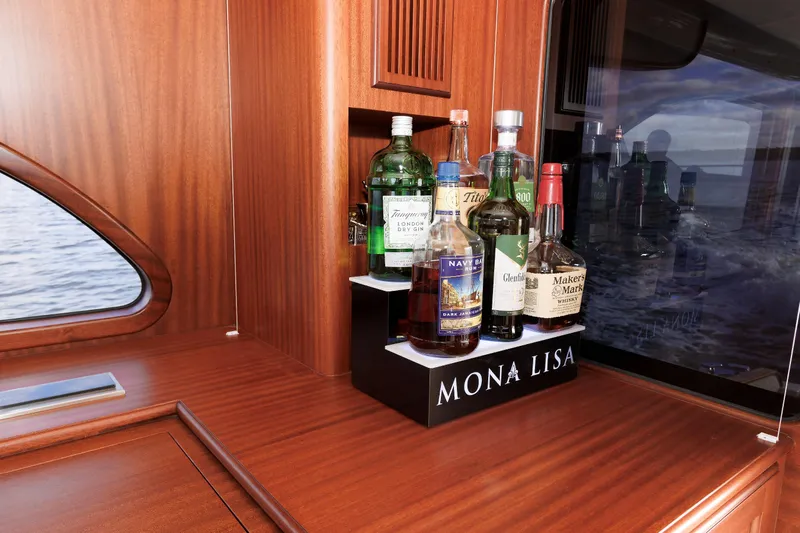 Mona Lisa Yacht Photos Pics Luxurious 2025 Vicem 58 Classic yacht interior with a well-stocked liquor shelf.