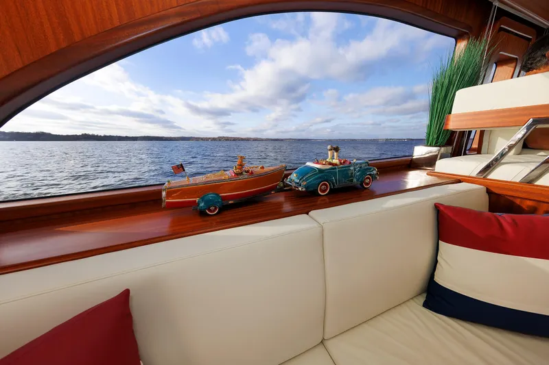 Mona Lisa Yacht Photos Pics Luxurious Vicem 58 Classic yacht interior with scenic ocean view, featuring elegant decor and model boats.