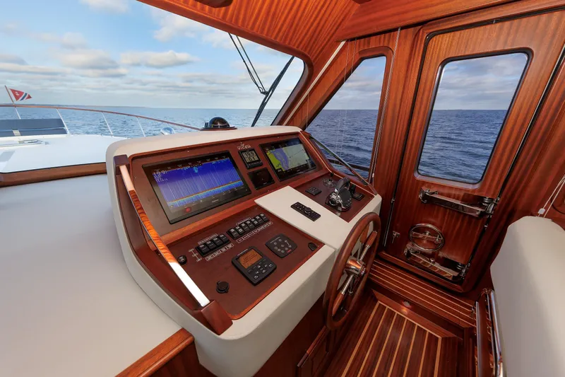Mona Lisa Yacht Photos Pics Helm of 2025 Vicem 58 Classic yacht with navigation screens and wooden finish.
