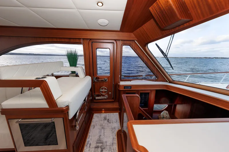 Mona Lisa Yacht Photos Pics Luxurious interior of 2025 Vicem 58 Classic yacht with elegant wood finish and ocean view.