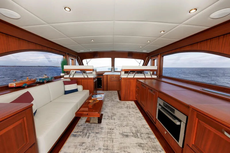Mona Lisa Yacht Photos Pics Luxurious interior of 2025 Vicem 58 Classic yacht with elegant wood finishes and ocean view.