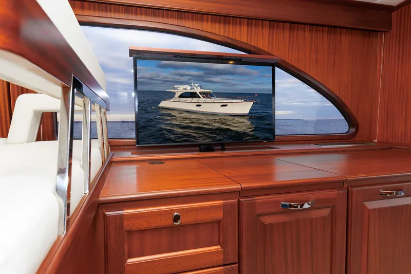 Mona Lisa Yacht Photos Pics Luxurious interior of 2025 Vicem 58 Classic yacht with wooden cabinetry and ocean view.