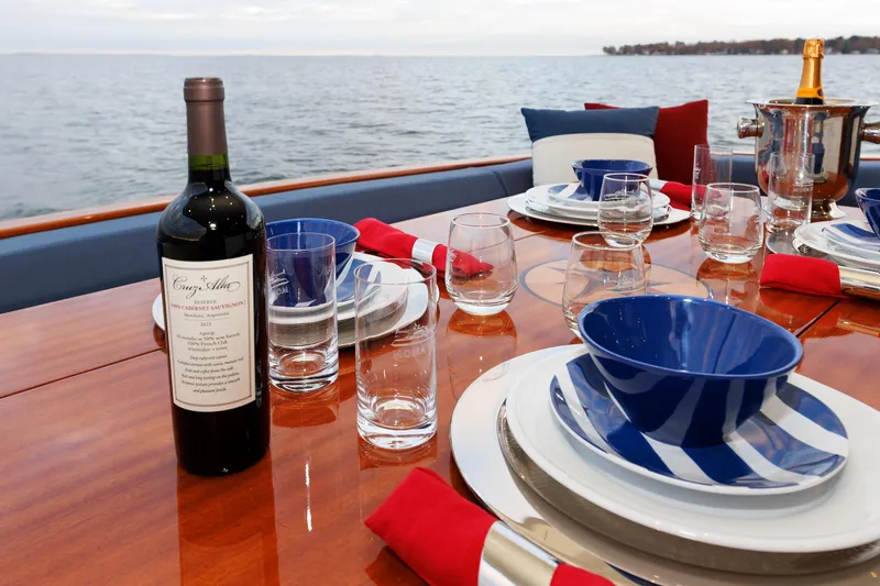 Mona Lisa Yacht Photos Pics Elegant dining setup on 2025 Vicem 58 Classic yacht with wine and ocean view.