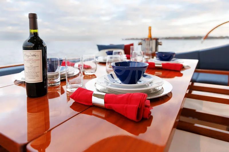 Mona Lisa Yacht Photos Pics Elegant dining setup on 2025 Vicem 58 Classic yacht with wine and ocean view.