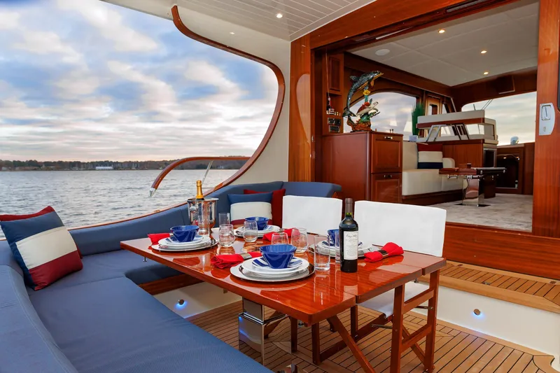 Mona Lisa Yacht Photos Pics Luxurious dining setup on 2025 Vicem 58 Classic yacht with scenic water view.