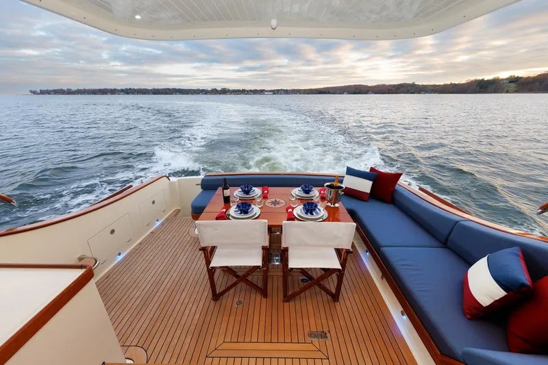 Mona Lisa Yacht Photos Pics Vicem 58 Classic 2025 yacht deck with elegant dining setup, cruising on serene waters.