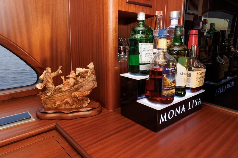 Mona Lisa Yacht Photos Pics Wooden yacht interior with liquor bottles and carved sculpture, Vicem 58 Classic 2025.
