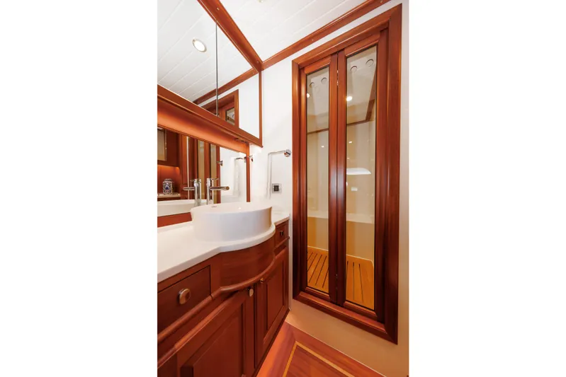 Mona Lisa Yacht Photos Pics Luxurious bathroom interior of 2025 Vicem 58 Classic yacht with elegant wood finishes.